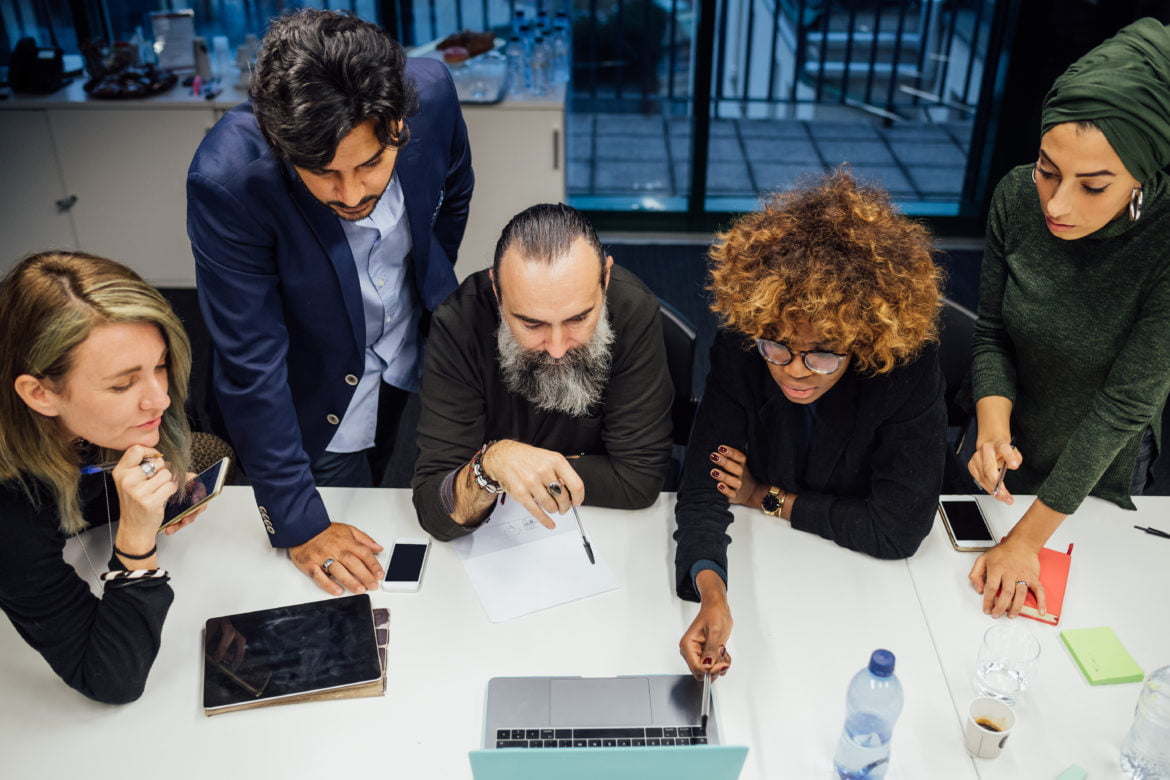 Business partners at brainstorming meeting in office | eClouds Salesforce Consultants Developers in New York